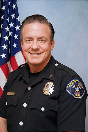 Profile picture of Gage Schlice, smiling in front of an American flag.