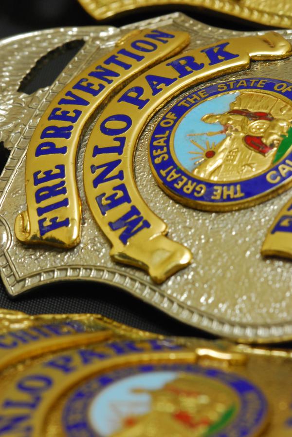 Close-up of a gold Menlo Park Fire Prevention Badge